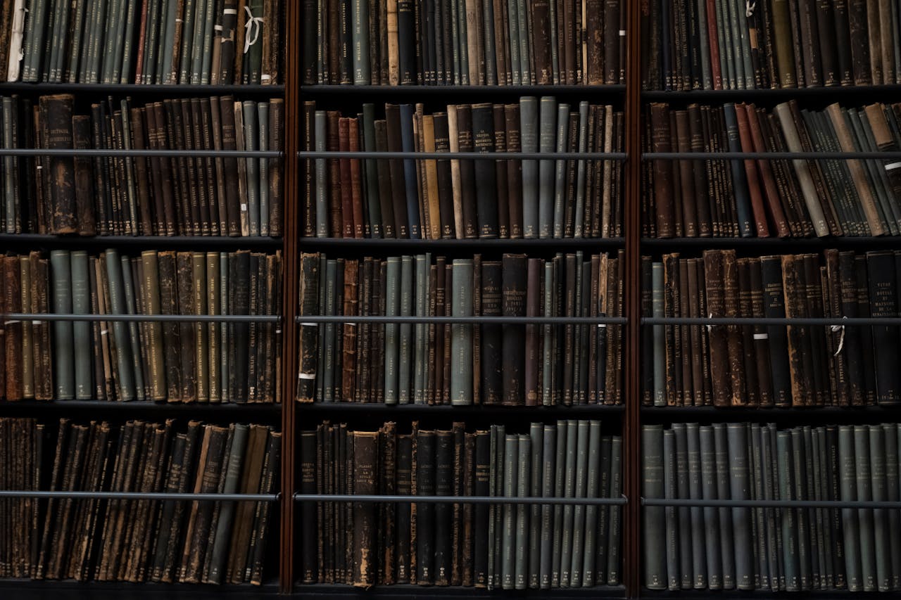 A close-up of vintage books on library shelves in London, showcasing an abundance of literary history.